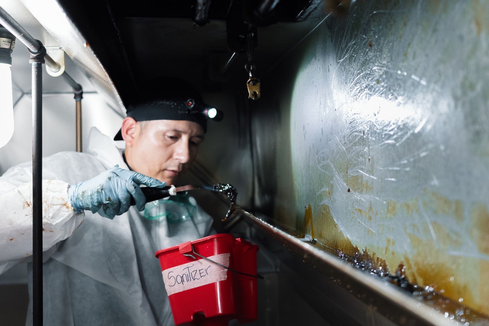 TruShine technician cleaning commercial kitchen hood interior surfaces