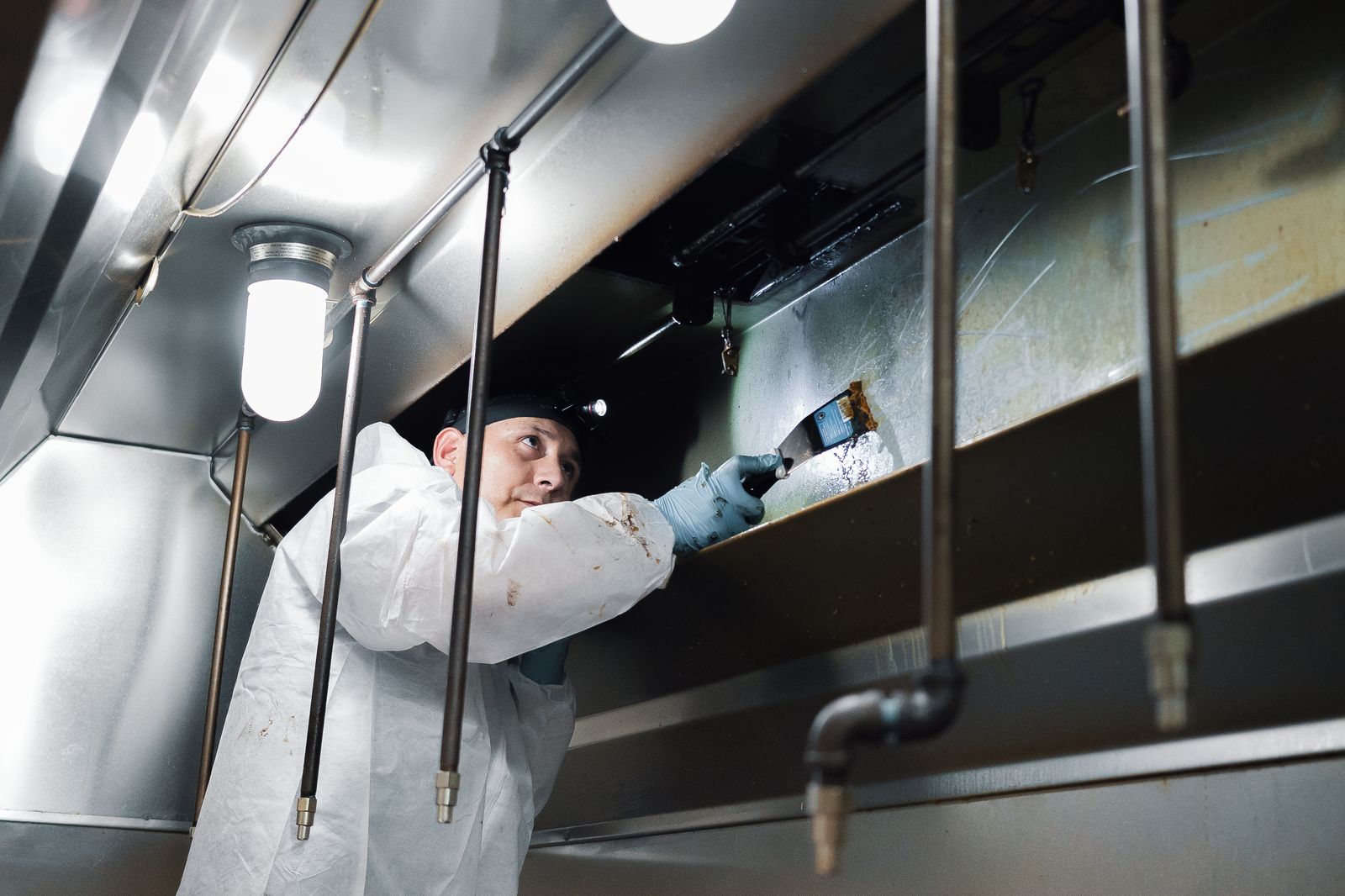 TruShine technician cleaning inside commercial kitchen hood ductwork